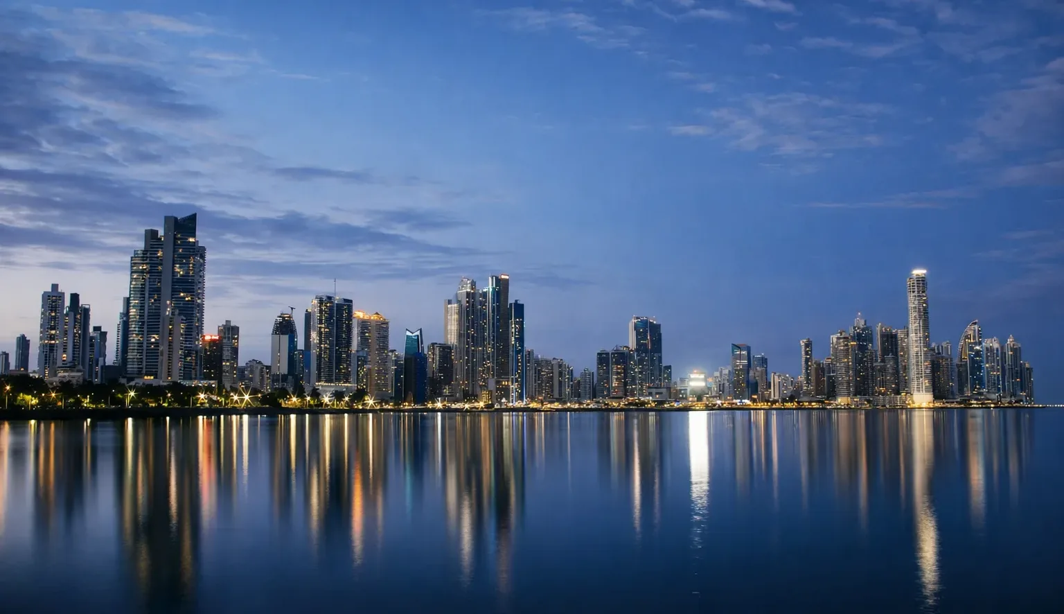 Luxury Panama City skyline at night with waterfront reflections